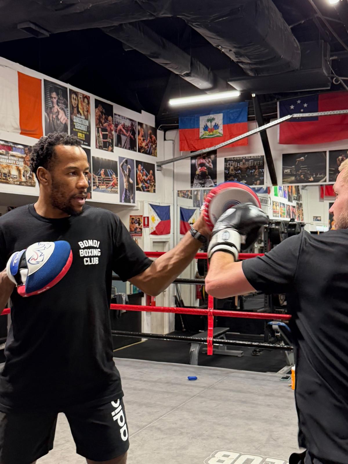 Etienne Ralph coaching on the pads at Bondi Boxing Club