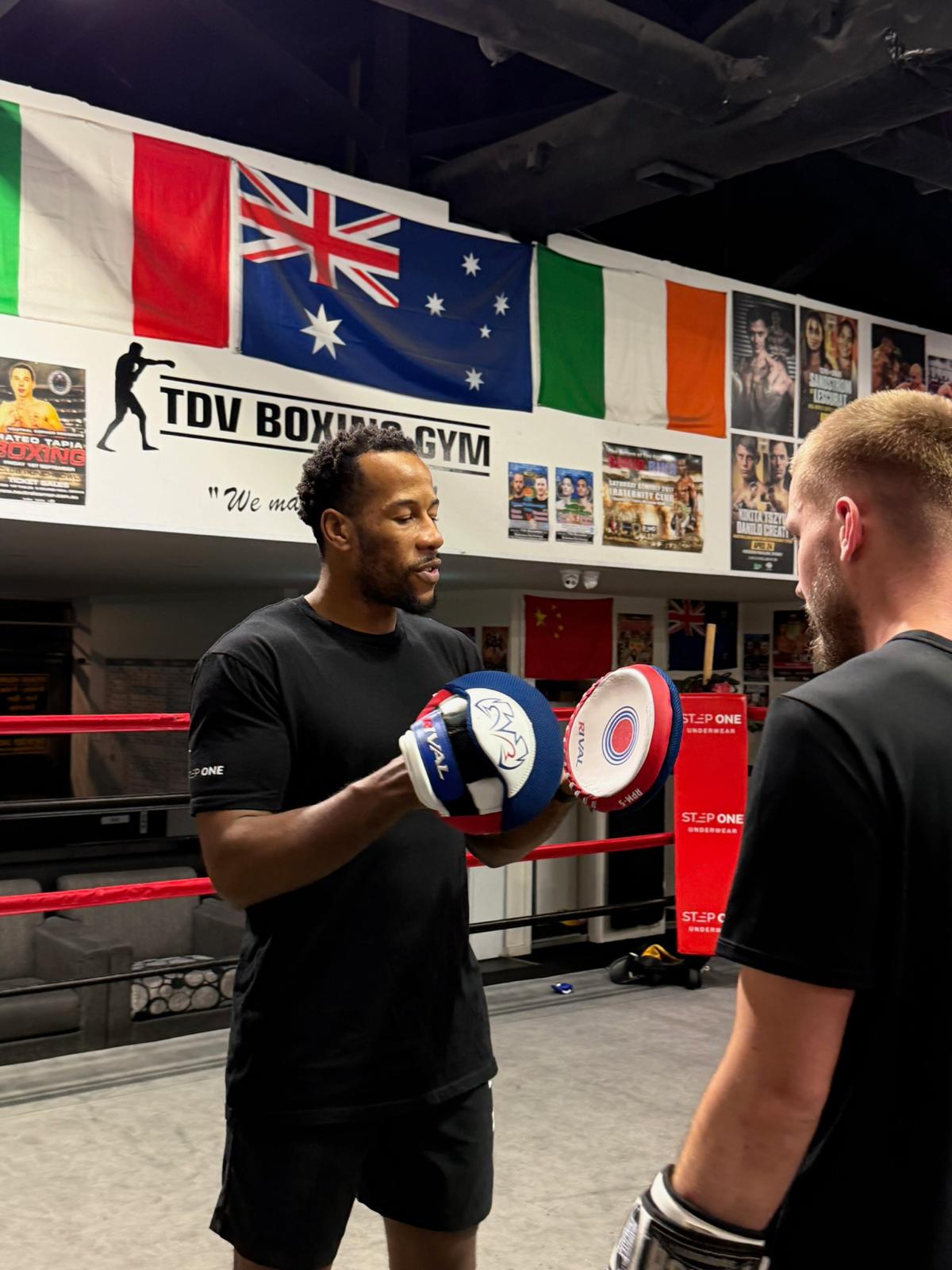 Etienne Ralph coaching on the pads at Bondi Boxing Club
